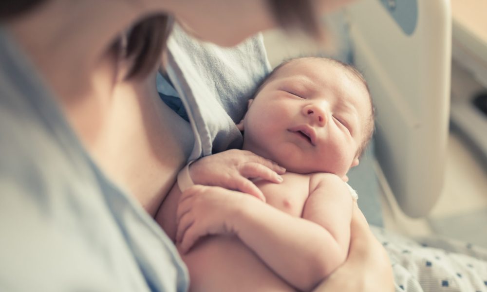 Parenting and new life concept. Mother holding newborn baby boy