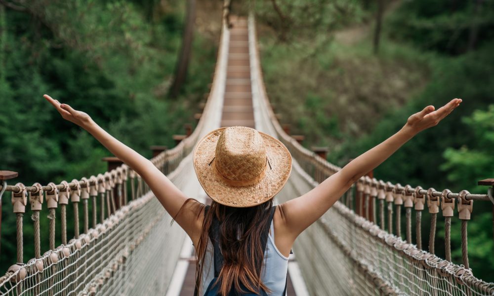 Happy travel woman on vacation concept. Funny traveler enjoy her trip and ready to adventure