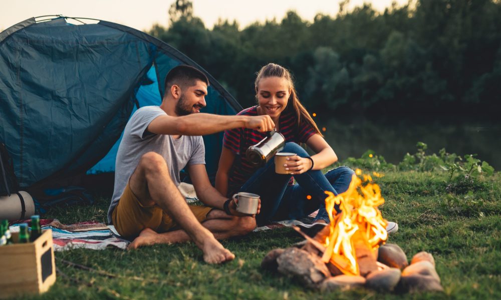 romantic couple on camping by the river outdoors