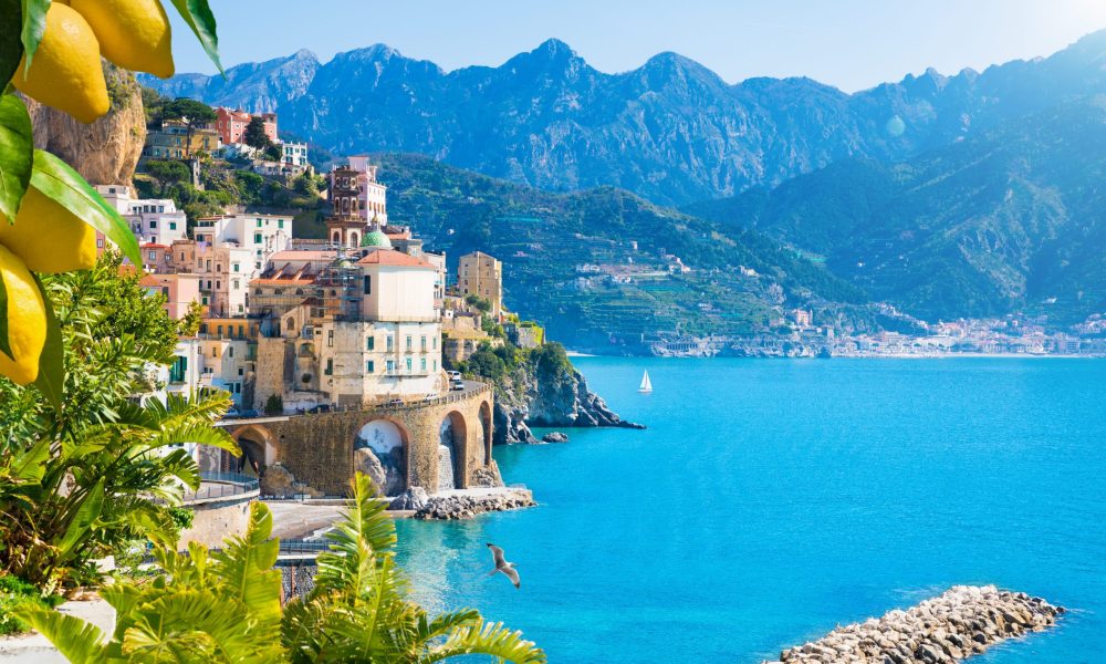 Small town Atrani on Amalfi Coast in province of Salerno, Campania region, Italy. Amalfi coast is popular travel and holyday destination in Italy. Ripe yellow lemons in foreground.
