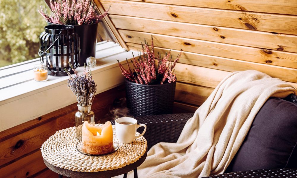 Cute autumn home decor arrangement. Tiny wooden cabin balcony wi