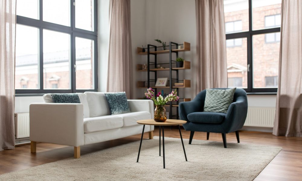 comfort, furniture and interior concept - sofa with cushions at cozy home living room