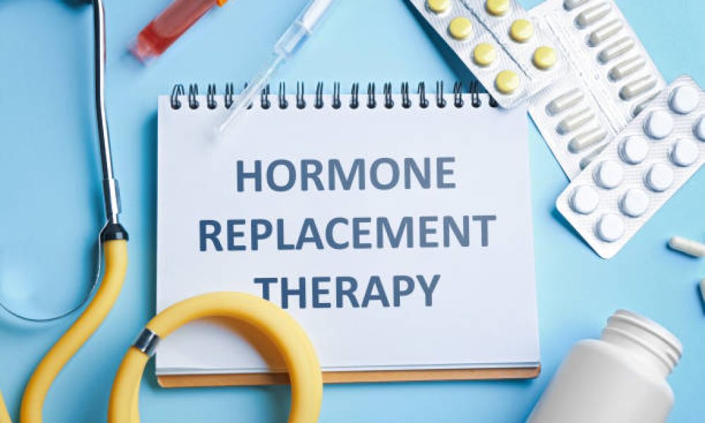 Notebook with text Hormone Replacement Therapy and medications on light blue background, flat lay