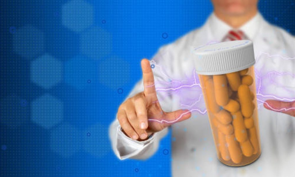 A doctor holds a bottle of pills for point out an issue