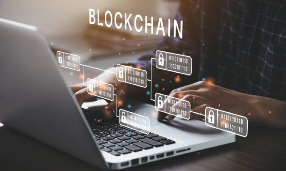 Businessman using a computer to Blockchain technology concept with a chain of encrypted blocks to secure cryptocurrencies and bitcoin for online payments and money transaction