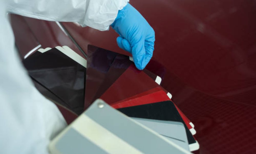 Car painter chooses auto body color with samples