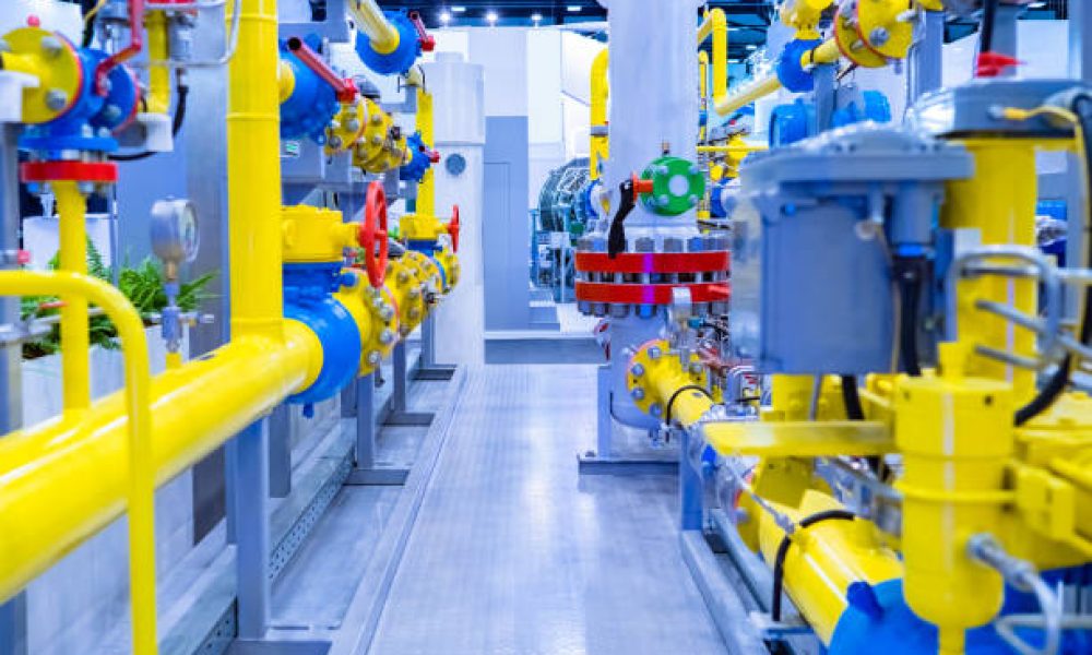 Gas distribution room at the enterprise. Yellow-blue pipes. Industrial equipment. Installation for pumping gas. Gasification of an industrial enterprise. Stationary compressor station.