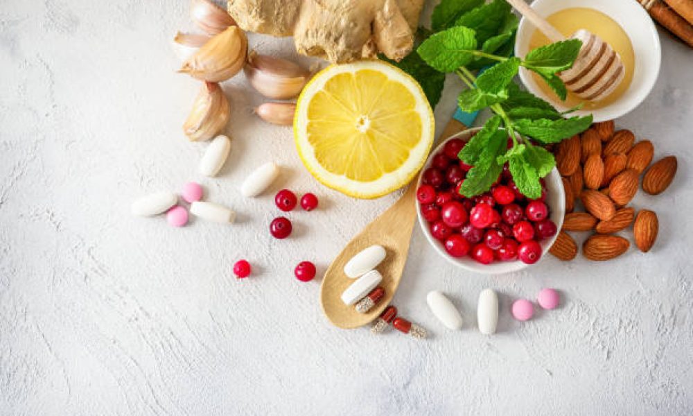 Various healthy natural products for immunity boosting and cold remedies on white background. Top view.