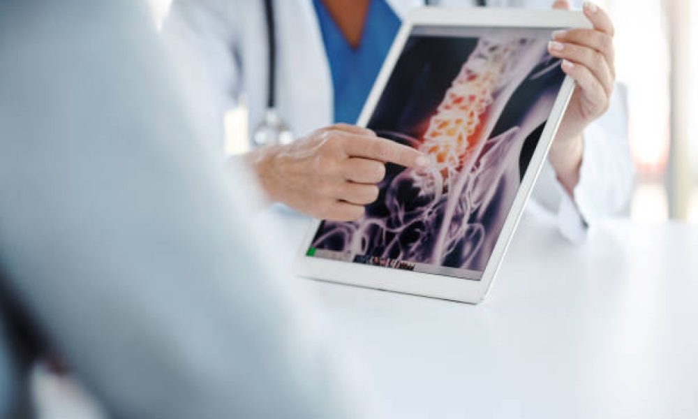 Shot of a doctor showing her patient his scan on a digital tablet
