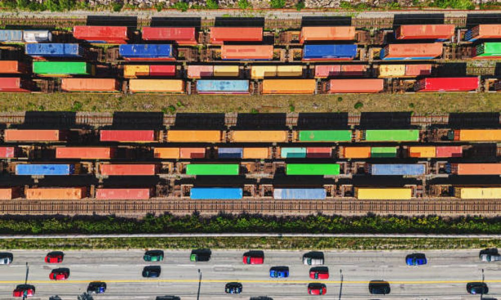 Aerial view of colorful railroad cars and traffic.