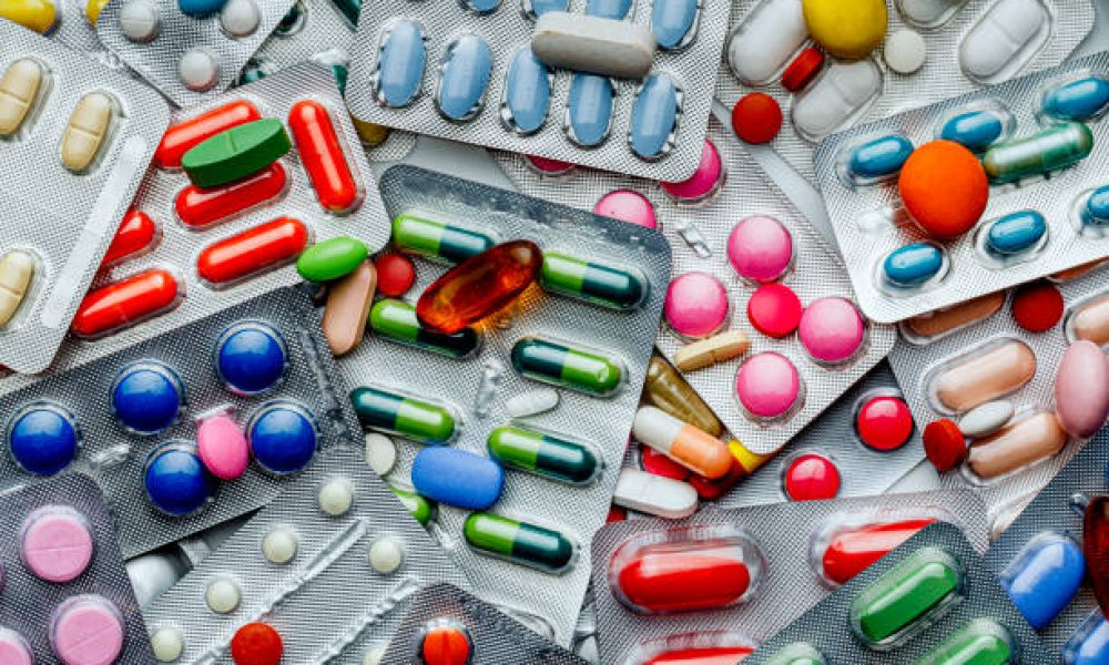 Health themes: Background of a large group of assorted capsules, pills and blisters. Drug abuse.