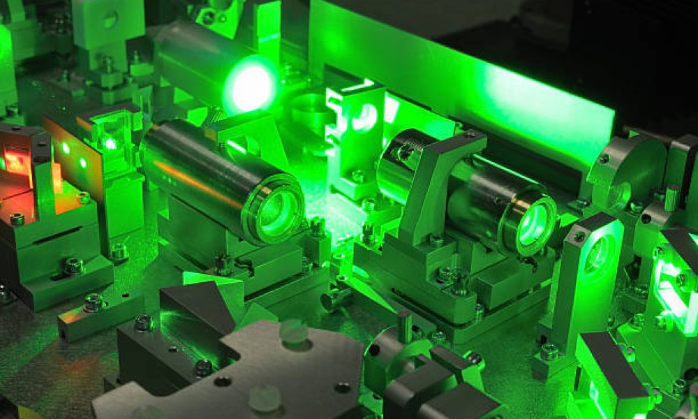 bright green laser light going inside complicate scientific system;selective focus on central part of image