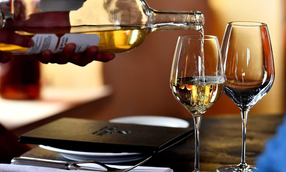 An person poors Sauternes wine on a glass on May 14, 2018 in Sauternes, western France.    A sweet wine that is savoured with foie gras at Christmas: it is this old-fashioned image that Sauternes wants to break by seducing a younger clientèle through wine tourism. This vineyard south of Bordeaux wants to regain its aura of yesteryear, when, during the prestigious ranking of the grands crus of 1855, the prices of the 27 castles Sauternes and Barsac exceeded those of Bordeaux reds. / AFP PHOTO / GEORGES GOBETGEORGES GOBET/AFP/Getty Images