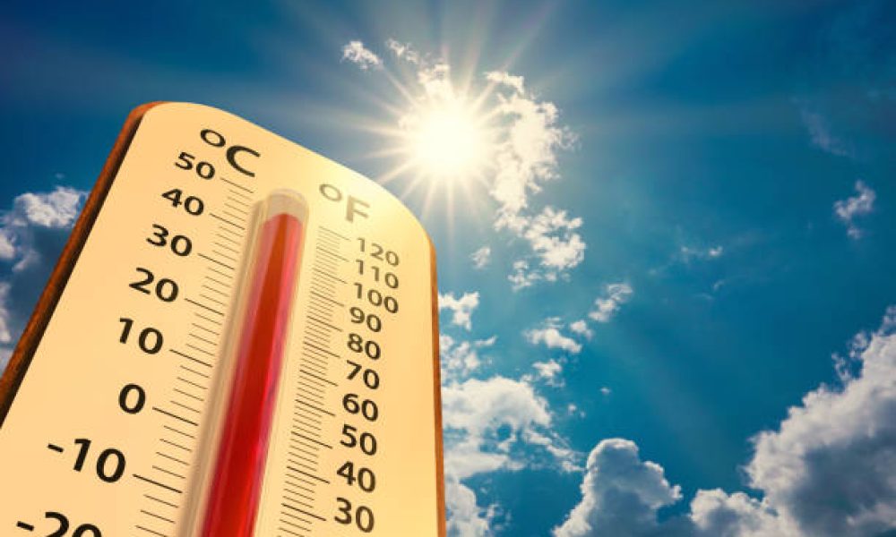 climate change, low angle view Thermometer on blue sky with sun shining in summer show increase temperature, concept global warming