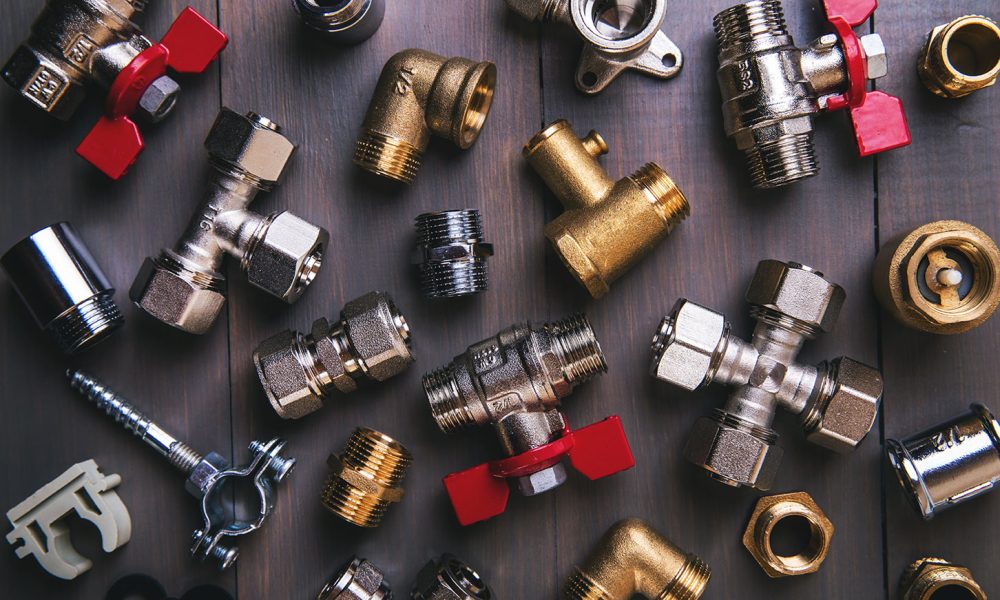 group of plumbing fittings and equipment on wooden background
