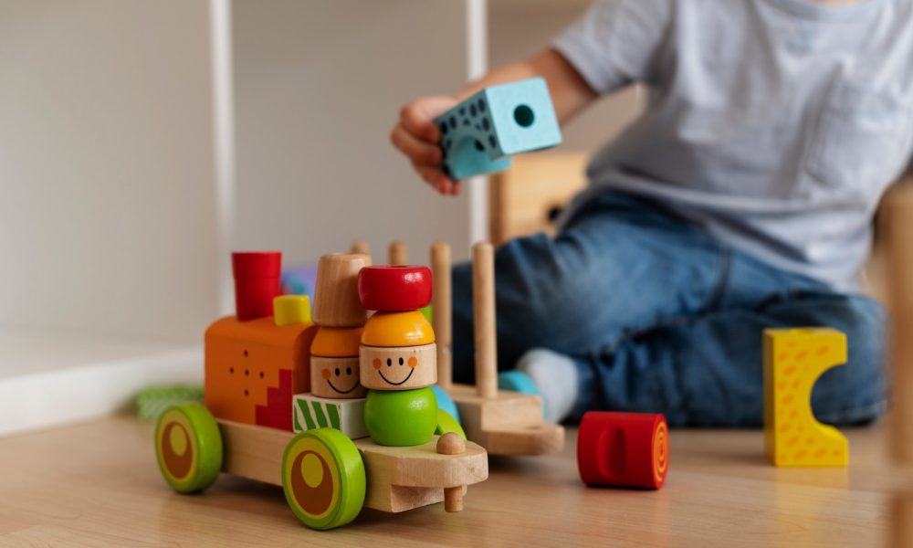 front-view-kid-playing-with-wooden-toyds_23-2149357210[1]