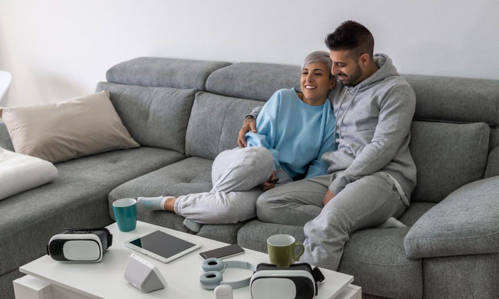 happy-young-couple-is-lying-new-couch-living-room-having-rest-bright-modern-apartment-with-stylish-furniture_181624-55768