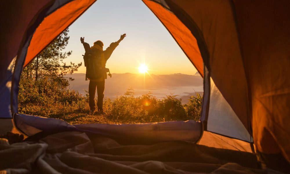 hiker-stand-camping-front-orange-tent-backpack-mountains_1150-9163[1]