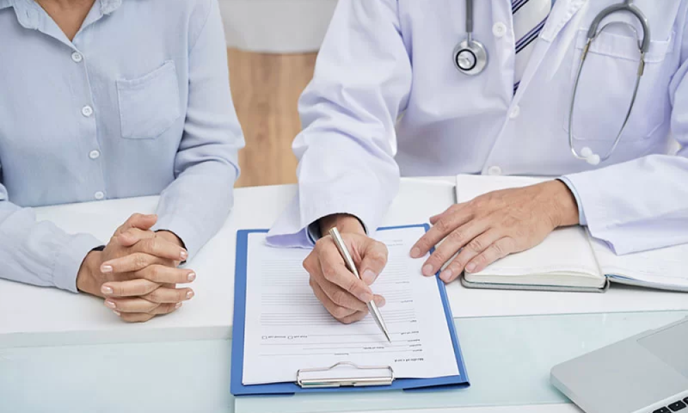 Board-certified physician reviewing workers compensation claim file for impairment rating dispute