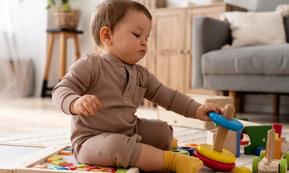 kid-playing-with-wooden-cars-full-shot_23-2149357275[1]