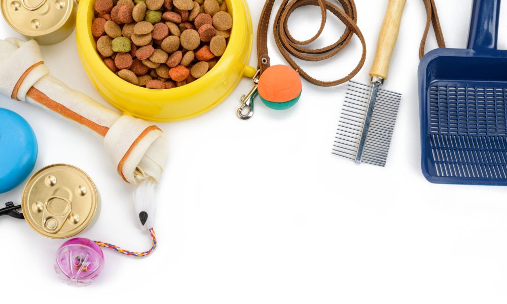 Pet food, toys and other supplies on white background, top view. Pet shop banner with copy space.