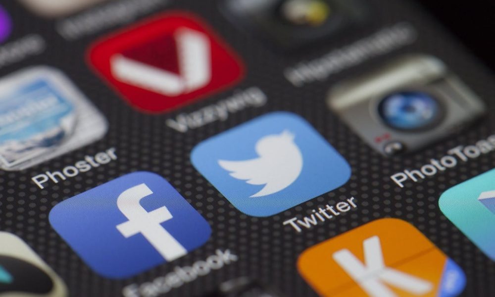 iphone displaying social media icons